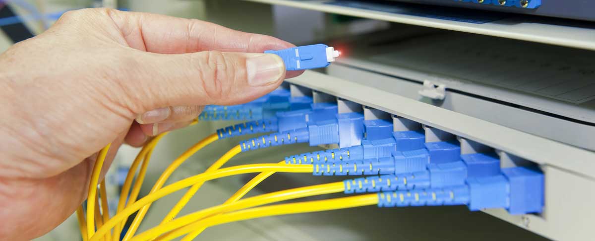 Network Technician plugging in network cables